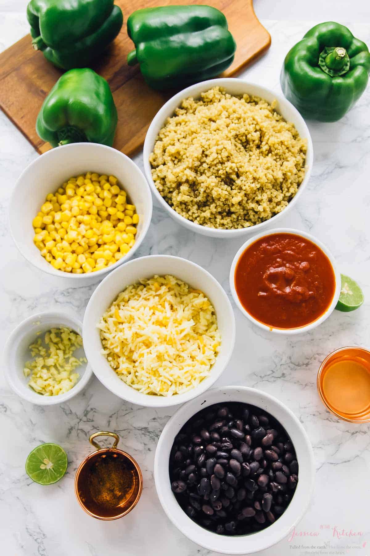 Top down shot of bowls of ingredients for stuffed peppers.