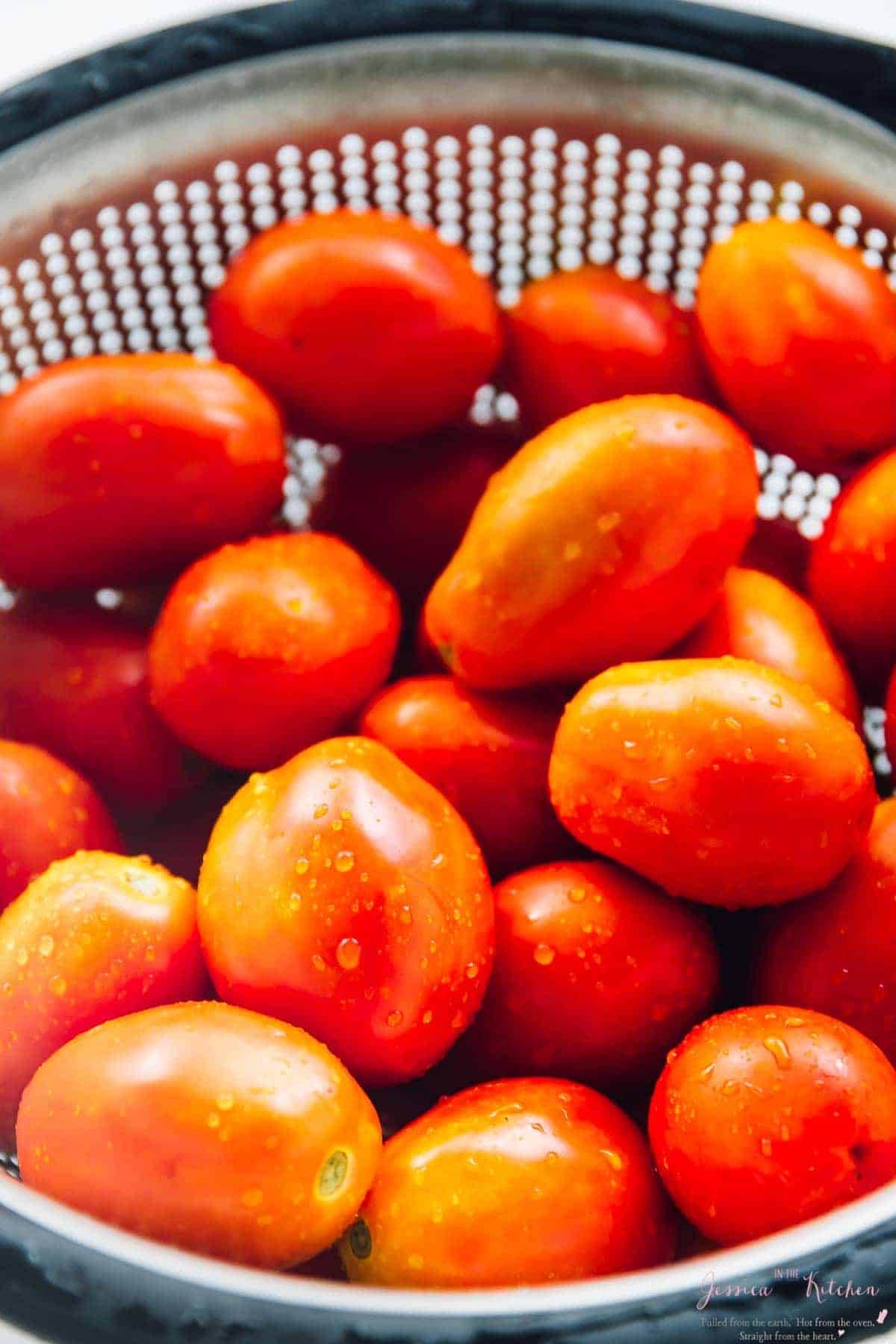 Close up of cherry tomatoes in a colander. 