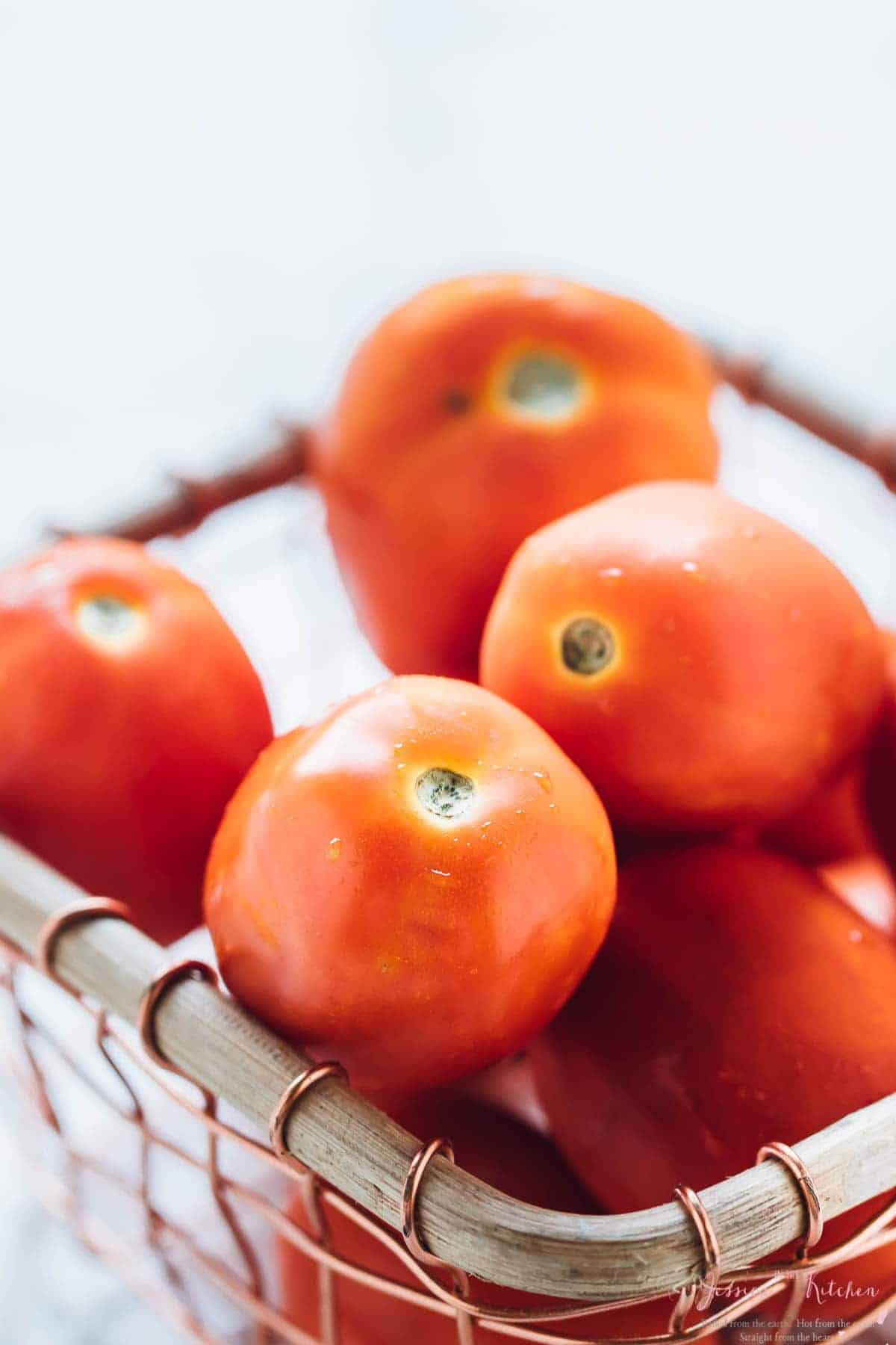 Close up of tomatoes in a wire basket 