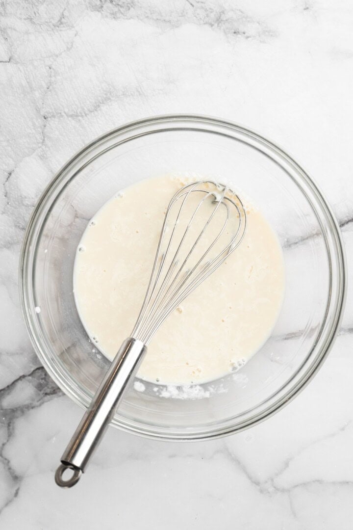 Vegan buttermilk in bowl with whisk