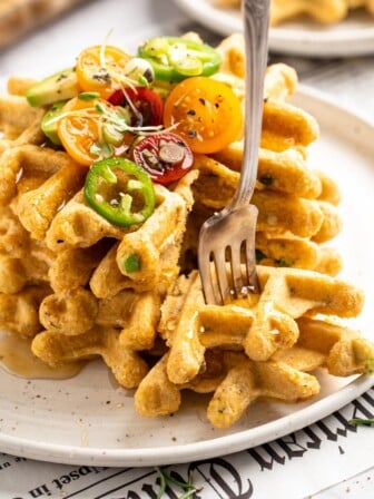 Fork sticking into pieces of cornbread waffles