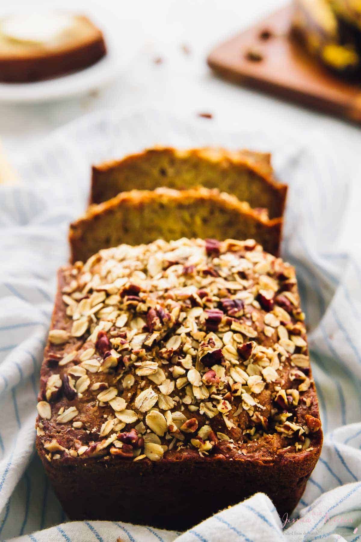 Sliced vegan gluten-free banana bread in flour sack towel