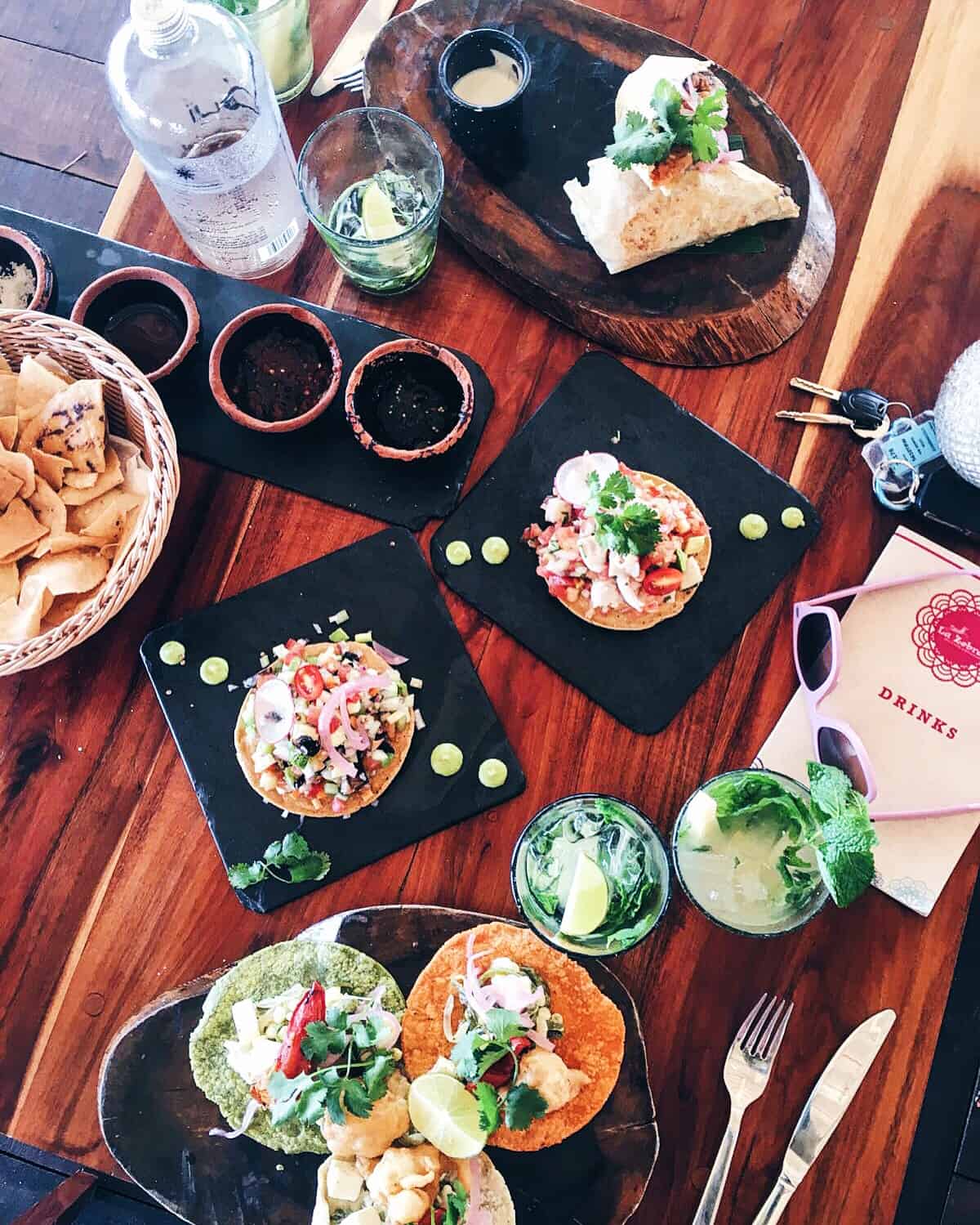 Overhead view of tostadas on a wood table.