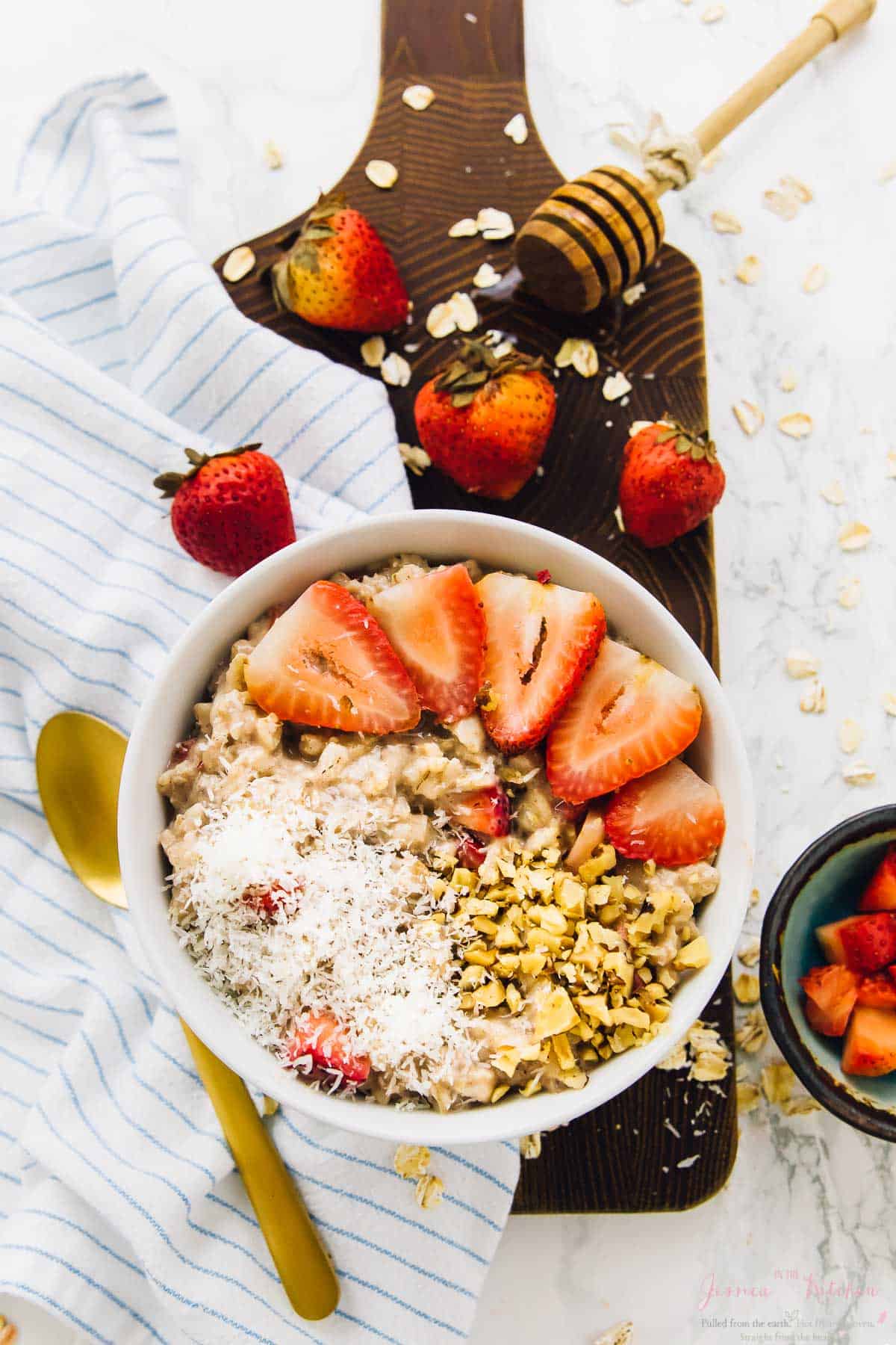 Top down view of strawberry coconut overnight oats on a wooden plank.