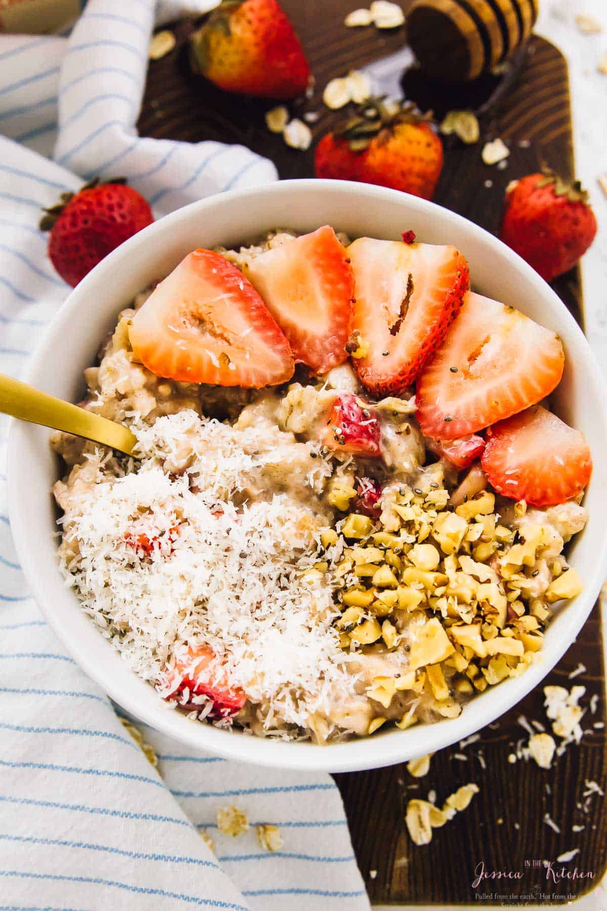 Bowl of strawberry coconut overnight oats garnished with coconut and sliced strawberries