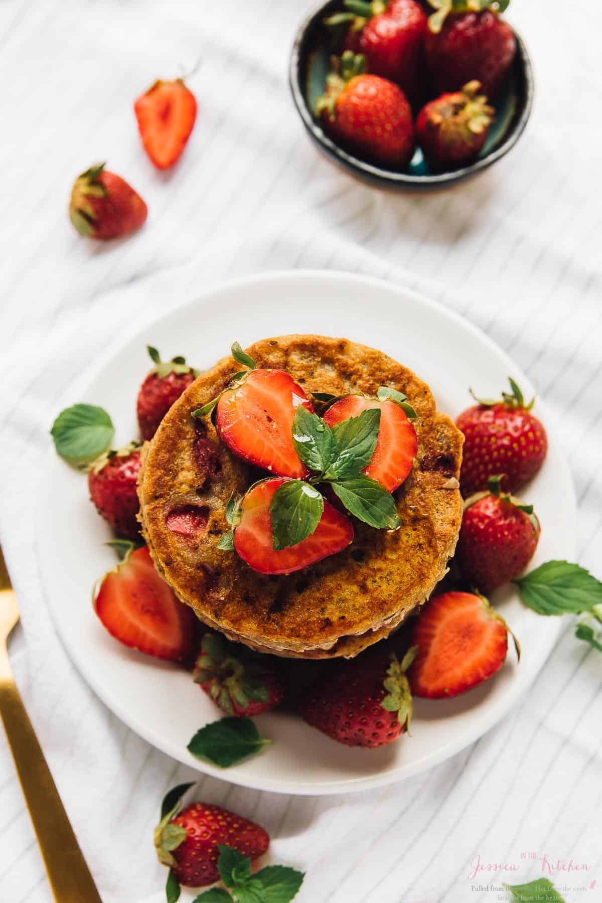 Overhead view of gluten-free vegan strawberry pancakes on plate