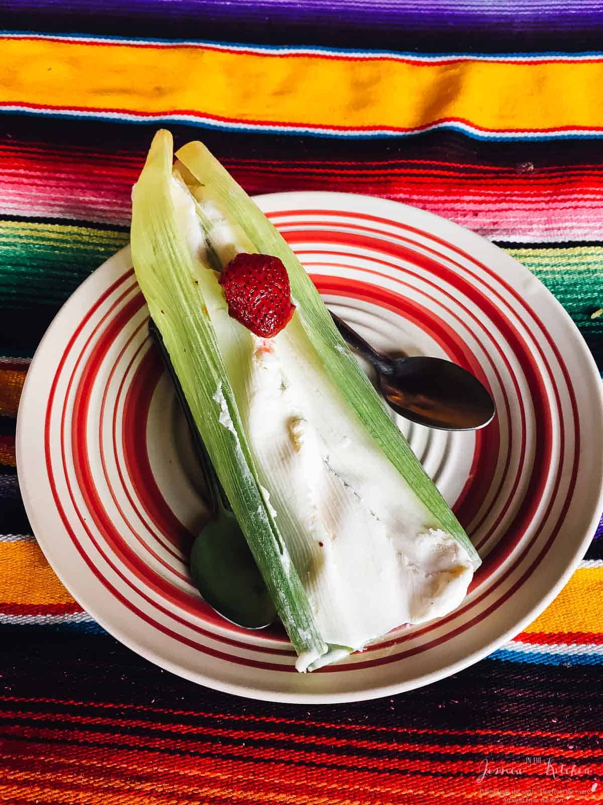 Top down view of ice cream in a leaf on a colorful plate. 