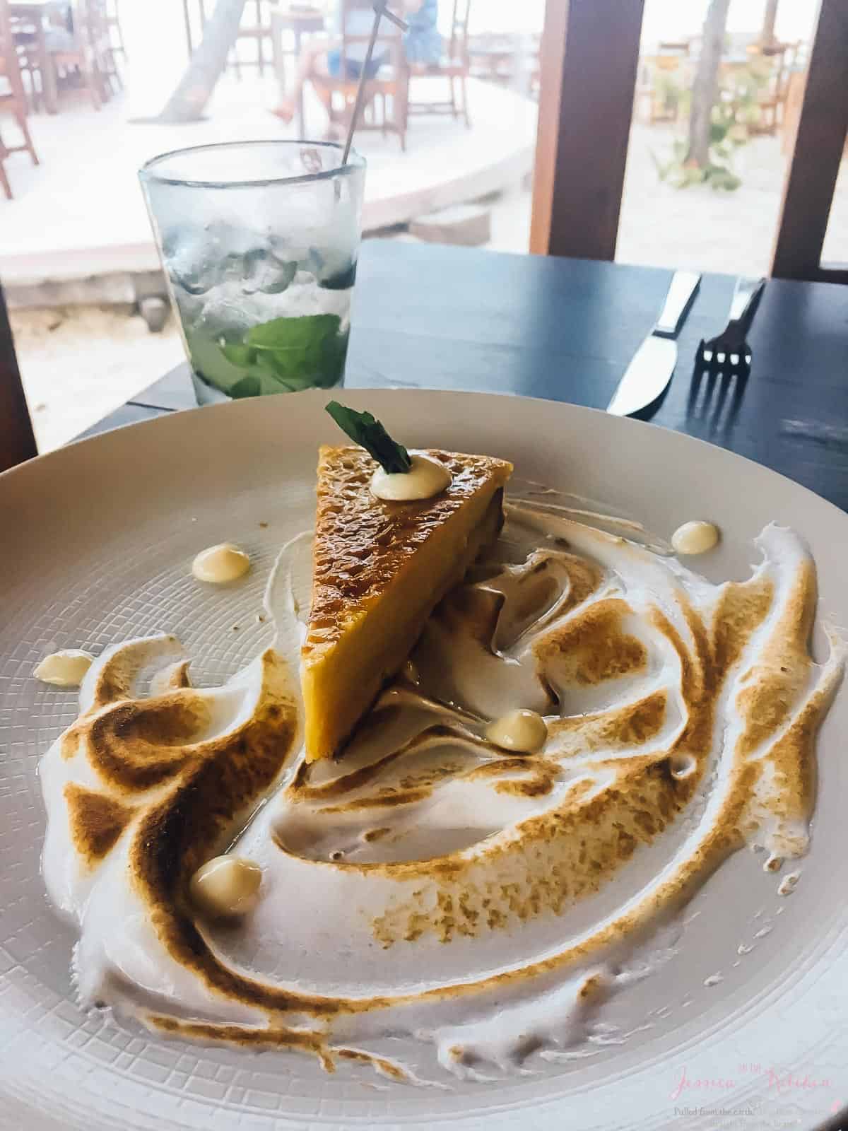 A slice of pie and meringue on a plate in a restaurant. 