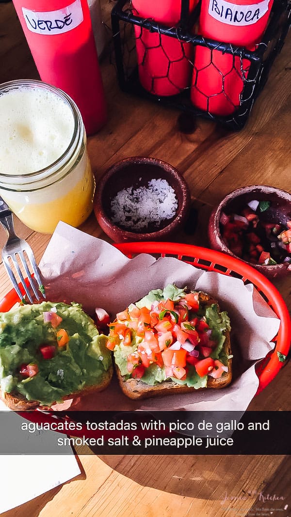 Avocado on toast in a red basket. 