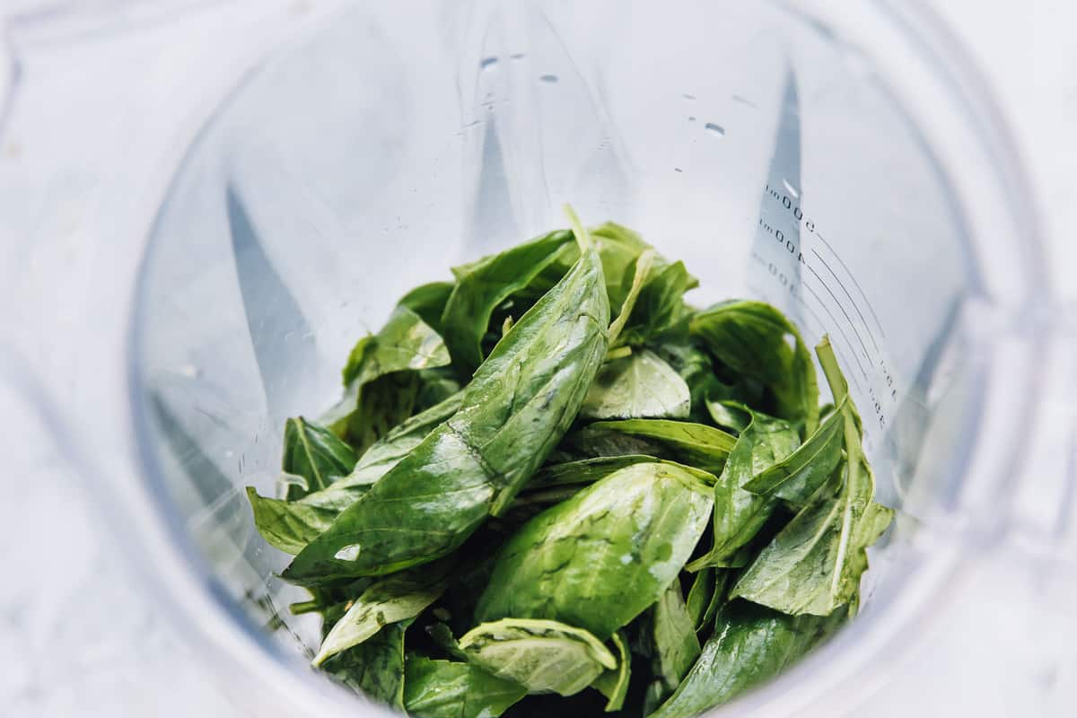 Basil leaves in a clear measuring jug. 