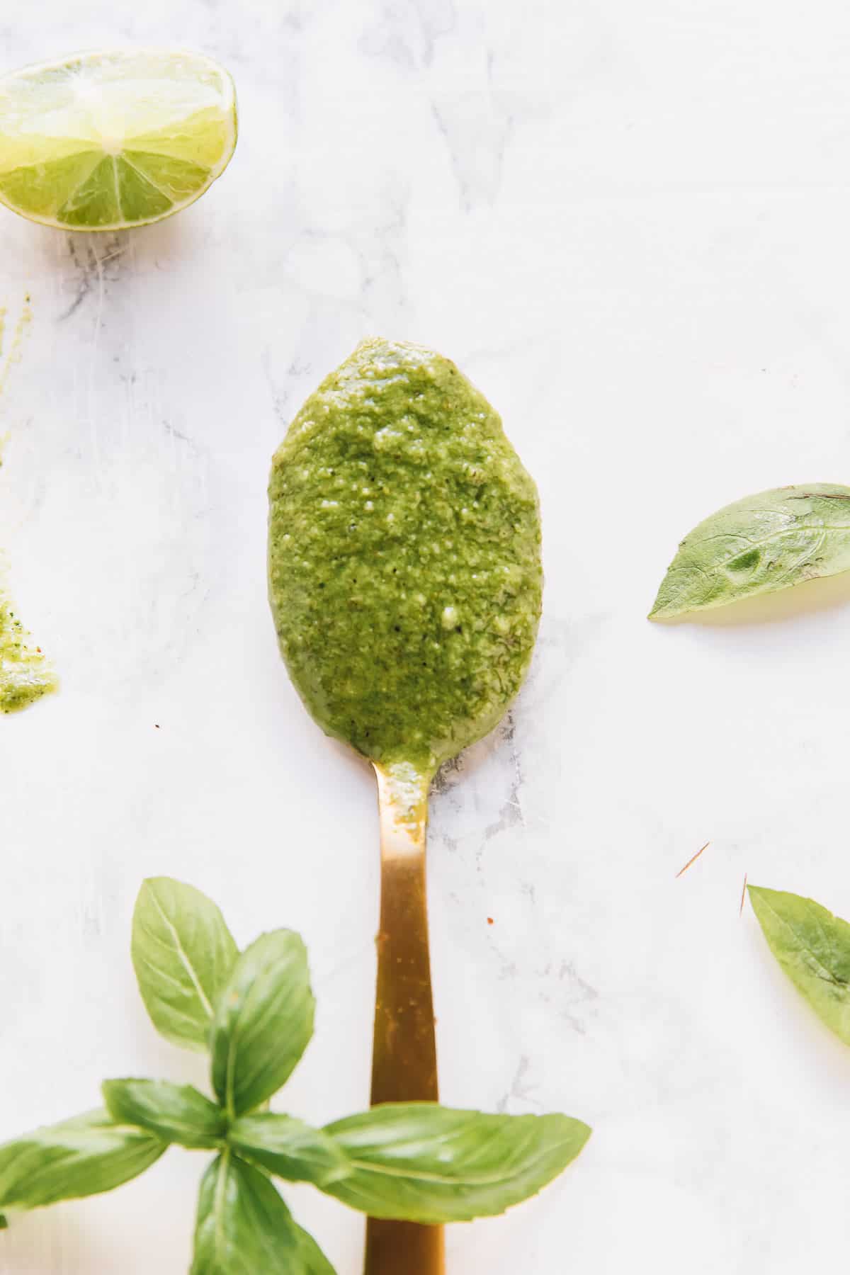 Overhead view of vegan basil pesto in a spoon