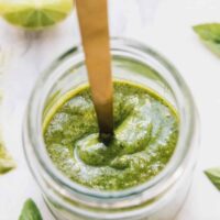 Top down shot of vegan pesto in a glass jar.