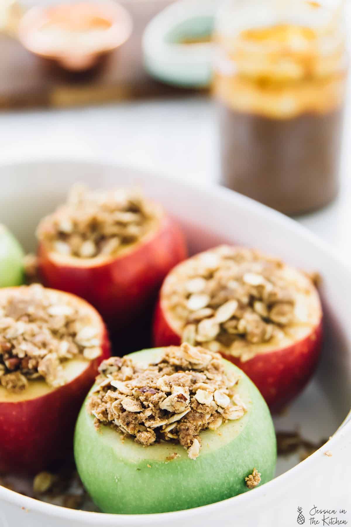 Close up of stuffed apples in a baking dish. 