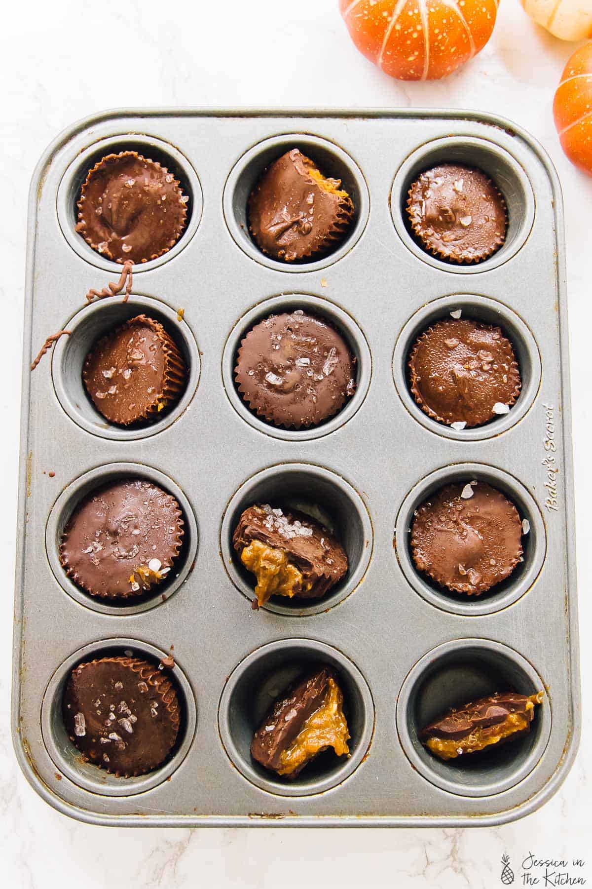 Overhead shot of salted caramel chocolate cups in a muffin tray.