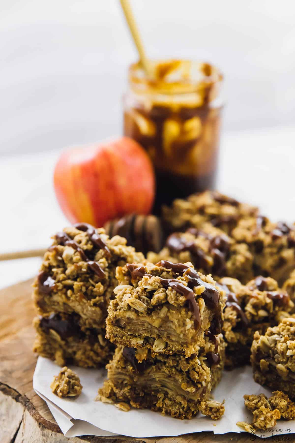 Vegan apple pie bars on a wood board. 