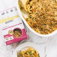 Top down view of pasta bake in a white baking dish with a box of pasta on the side.