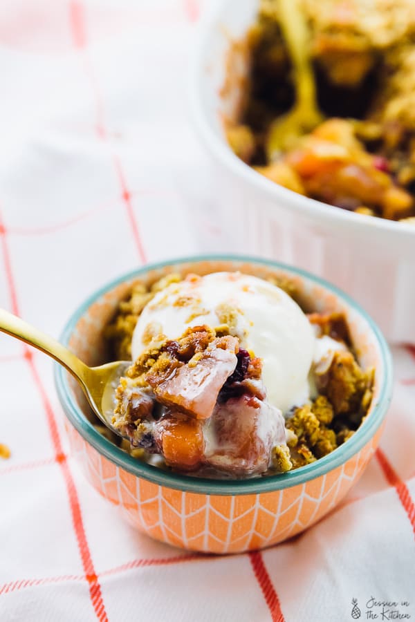 Cranberry apple crisp in an orange bowl. 