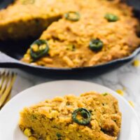 A portion of cornbread on a plate.