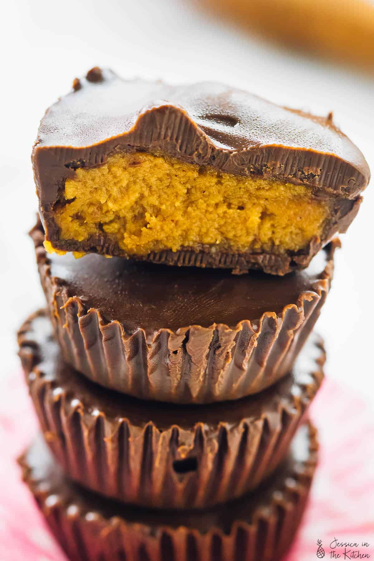 Close of a stack of pumpkin chocolate cups.
