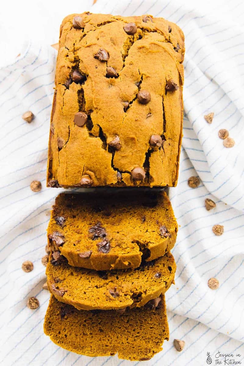 Top down view of pumpkin bread, partially sliced. 