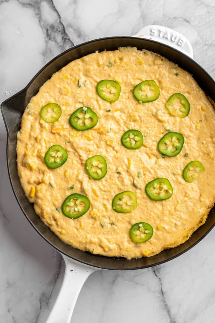 Pumpkin cornbread in skillet before baking