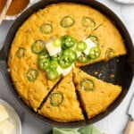 Overhead view of sliced pumpkin cornbread in skillet - 8