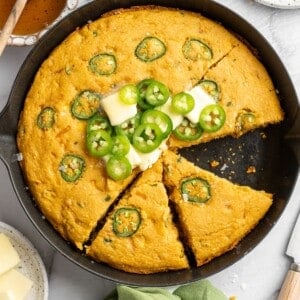 Overhead view of sliced pumpkin cornbread in skillet