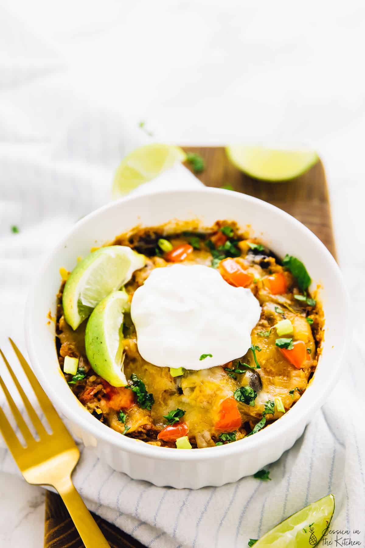 Quinoa enchilada casserole in a white ramekin. 