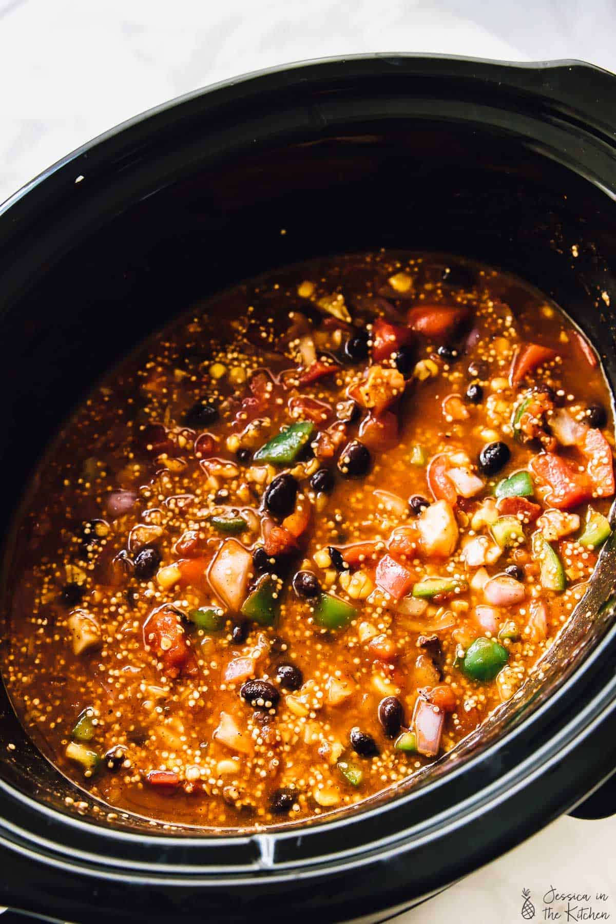 Slow cooker quinoa enchilada casserole in a black pot. 