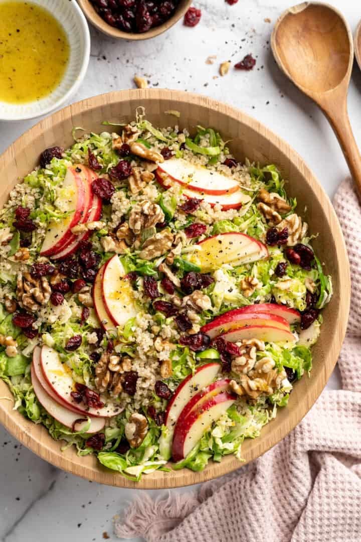 Overhead view of shaved brussels sprouts salad in serving bowl.