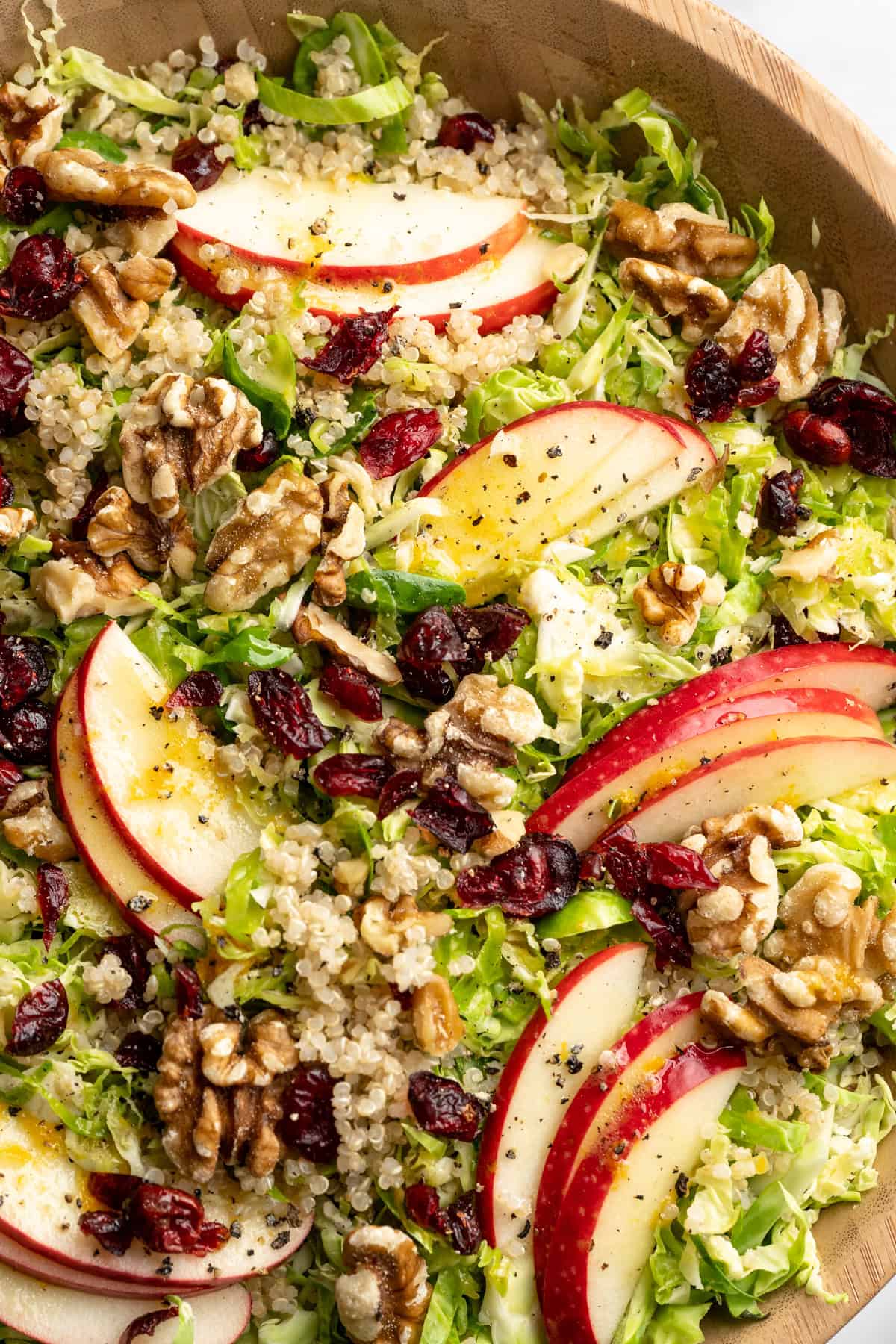 Shaved Brussels sprout salad with walnuts, quinoa, sliced apple, and cranberries.