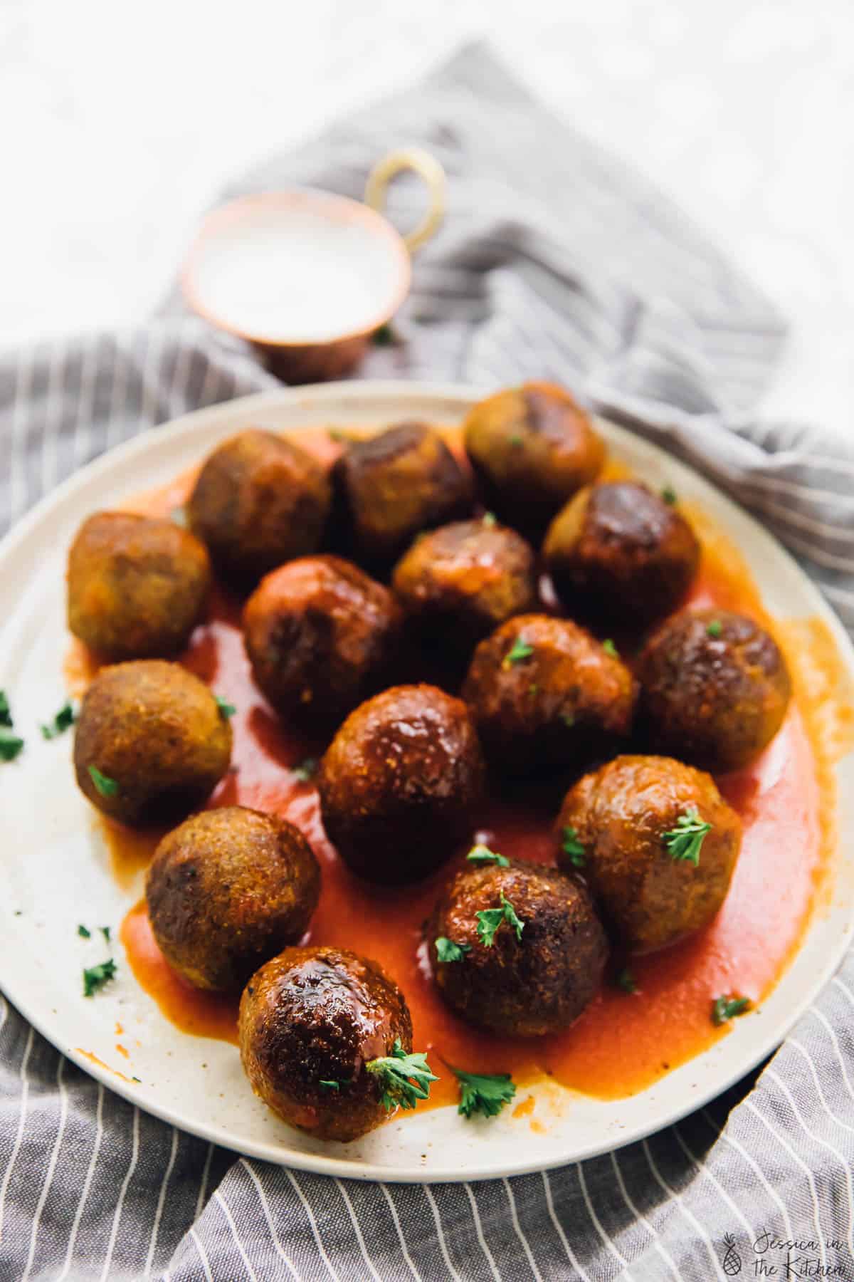 A plate of vegan meatballs on a white plate. 