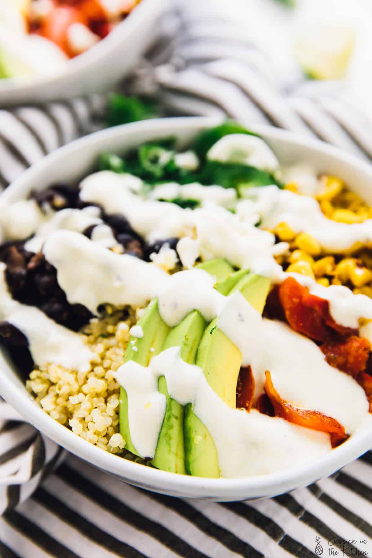 Mexican street corn burrito bowl topped with lime crema