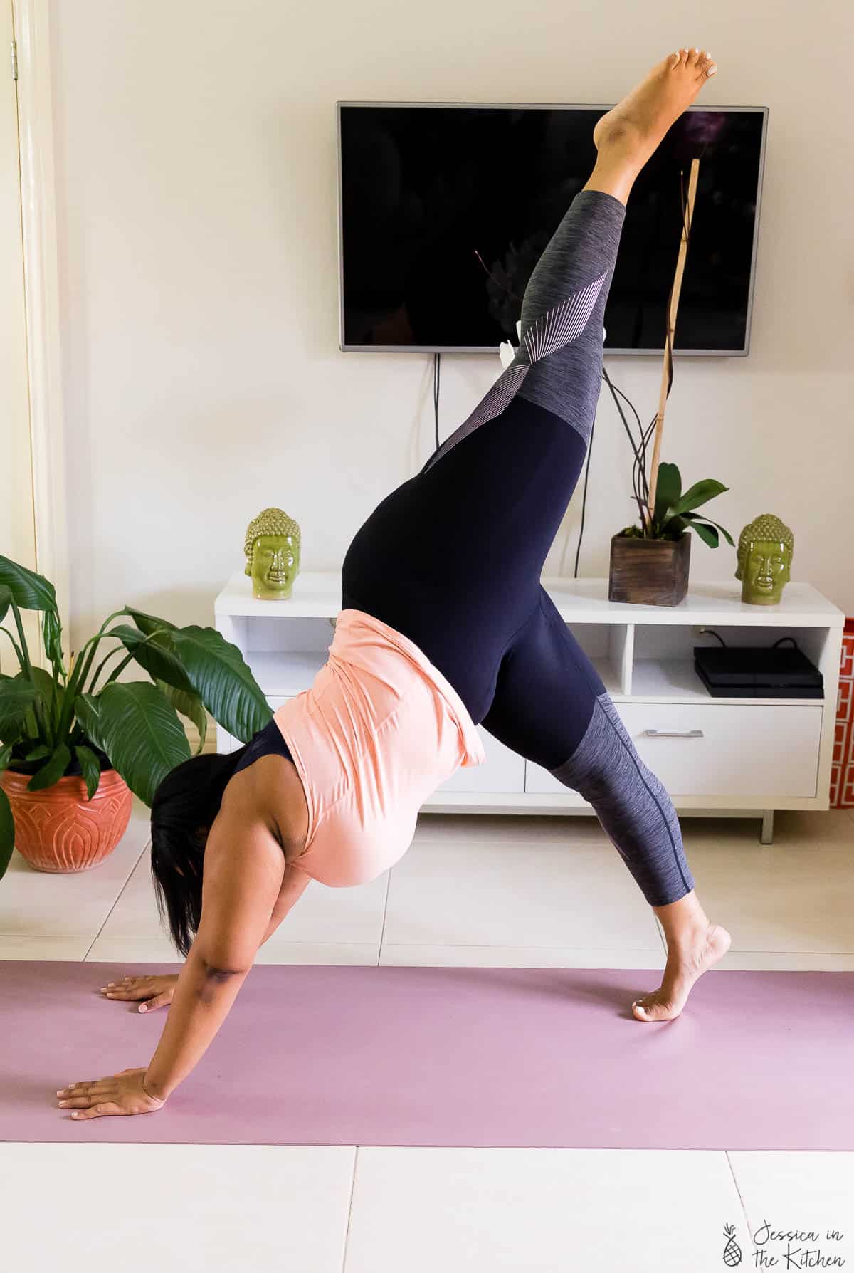 Jessica on a yoga matt doing a yoga pose. 