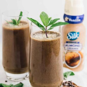 Two glasses of coffee shake, garnished with mint leaves.