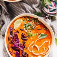 Top down shot of coconut curry soup in two bowls.