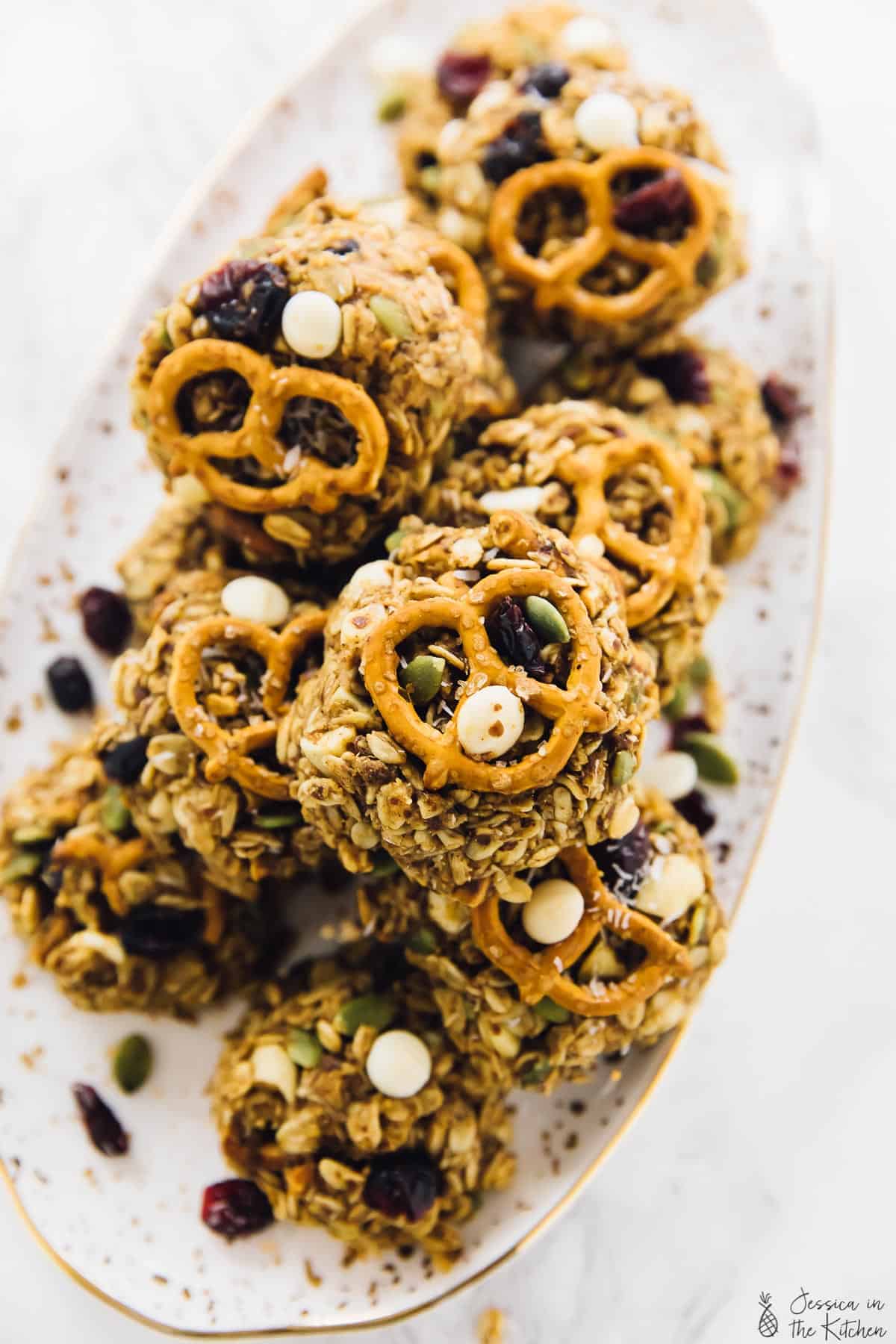 Overhead view of trail mix cookies piled on a plate. 