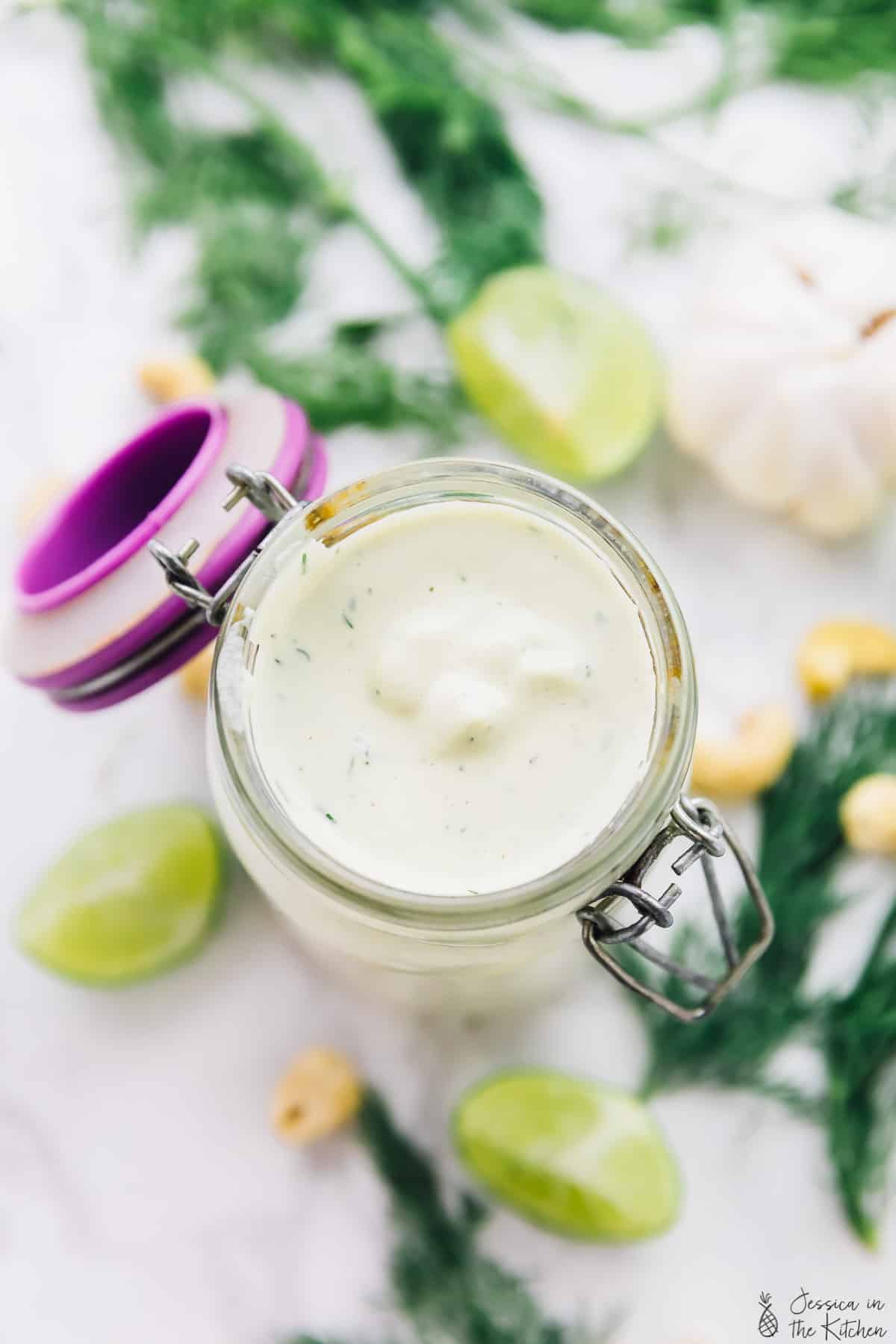 Top down view of ranch dressing in a glass jar.