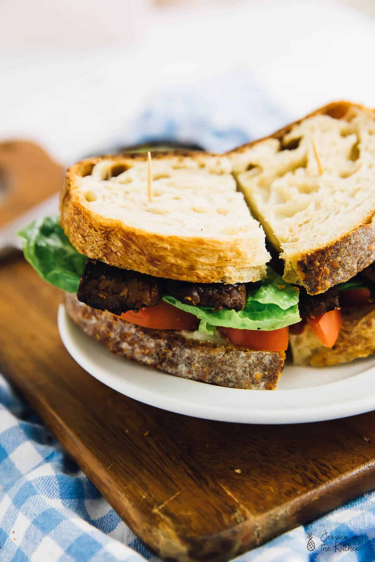 A vegan blt sandwich on a wooden board.