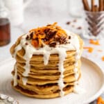 Stack of carrot cake pancakes with maple cream cheese drizzle. - 19