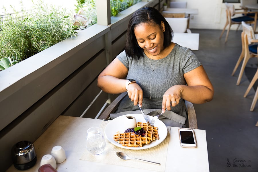 Jessica eating a waffles in a restaurant. 