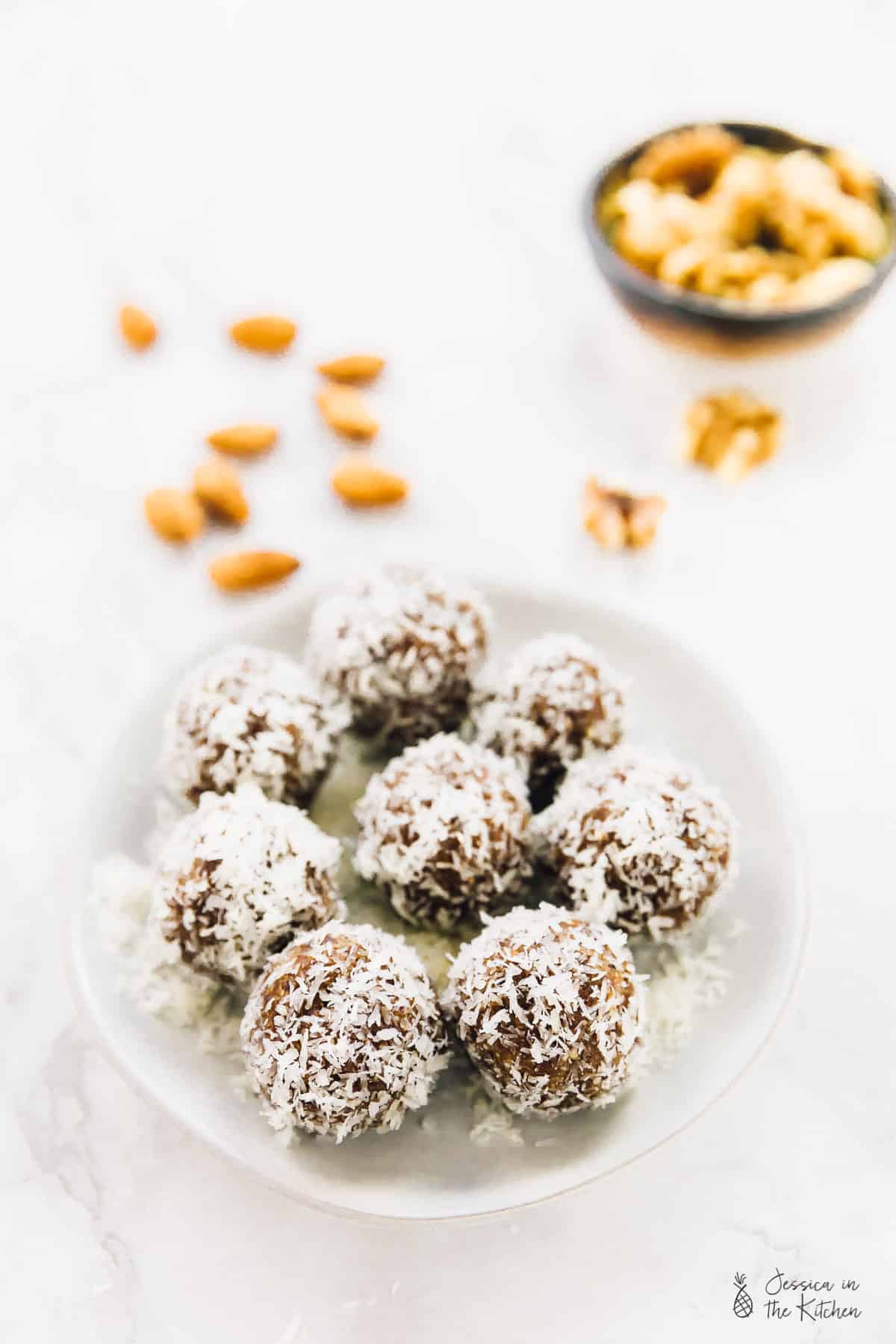 Coconut energy bites on a white plate.