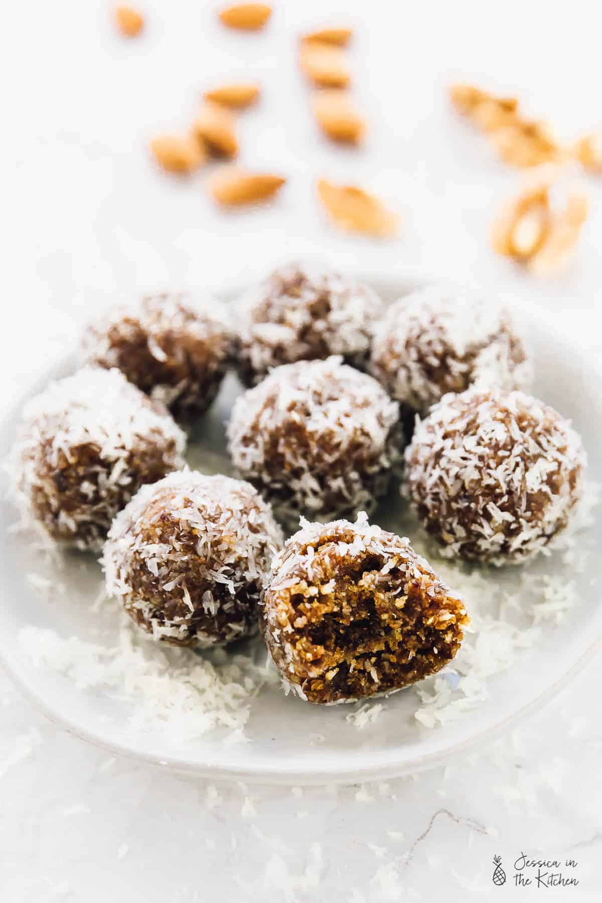 Coconut lemon energy bites on a glass plate. 