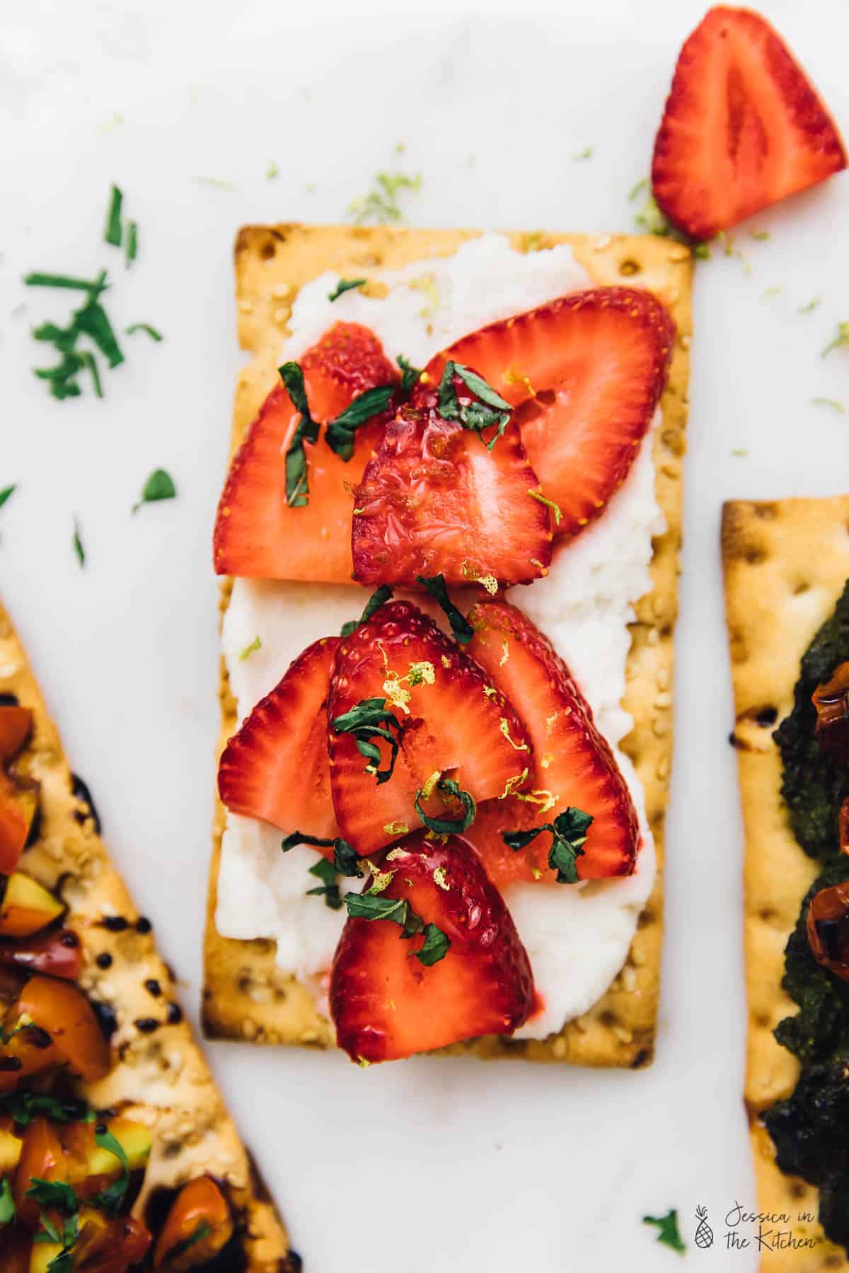 Top down view of chopped strawberries on crisp bread. 