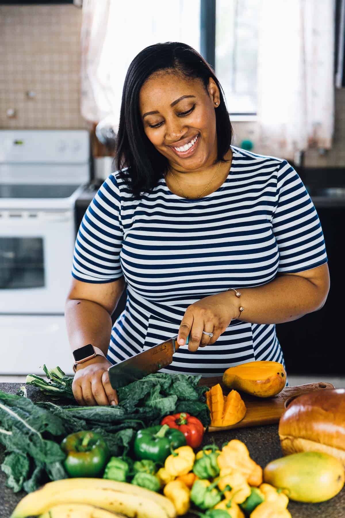 Jessica chopping vegetables in the kitchen. 