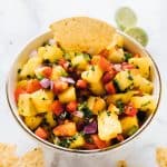 Bowl of fresh pineapple salsa recipe with a corn chip. - 5