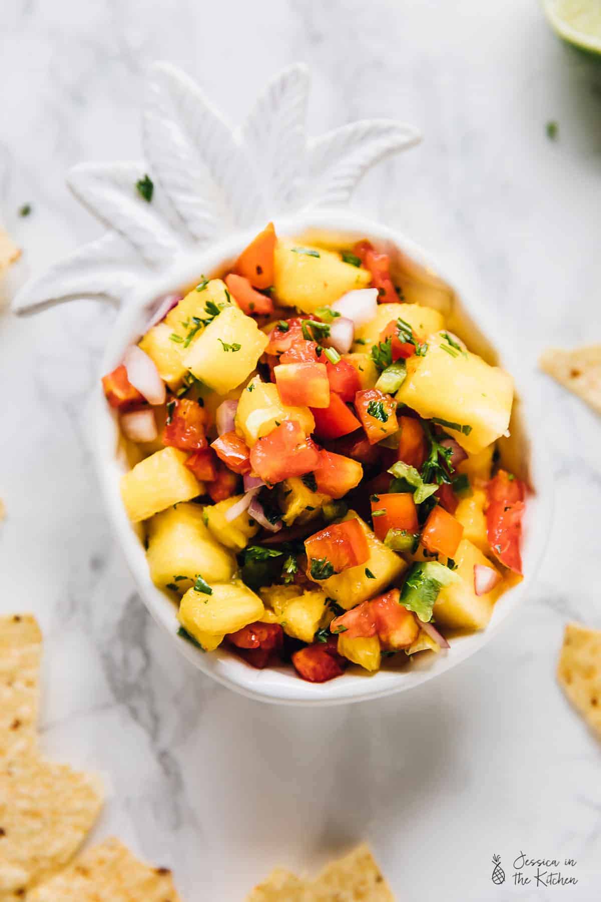 Top down view of pineapple salsa in a pineapple shaped bowl. 