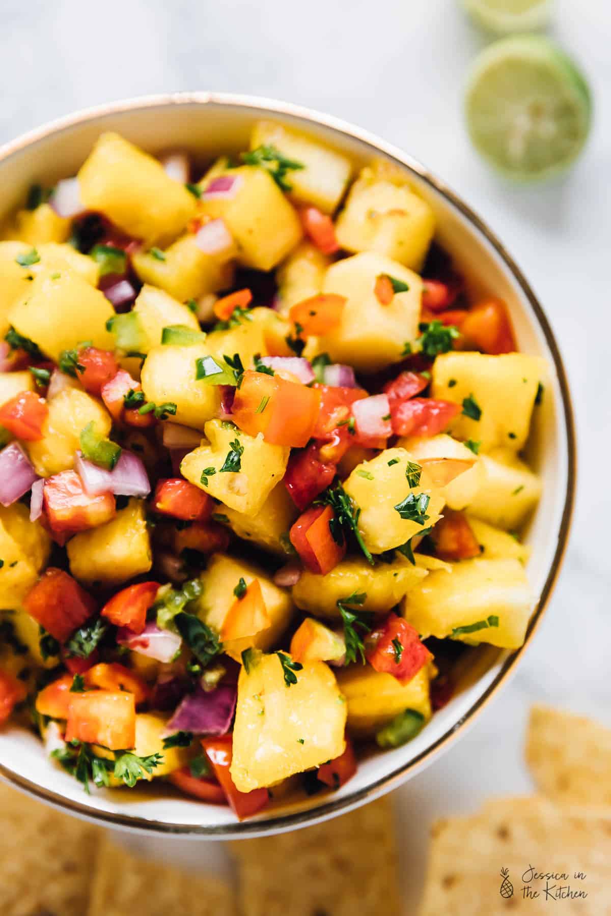 Overhead shot of pineapple salsa in a white bowl. 