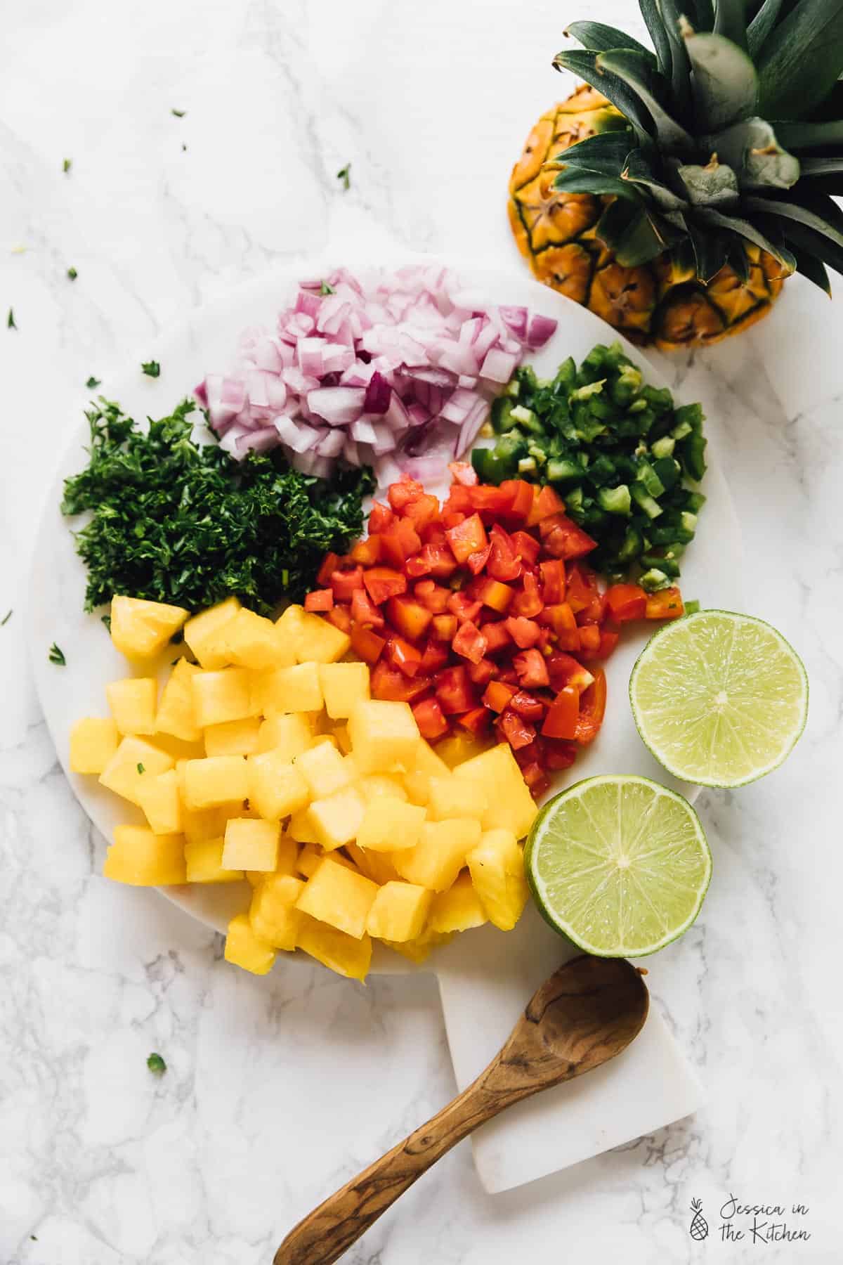 Top down view of diced vegetables on a plate. 