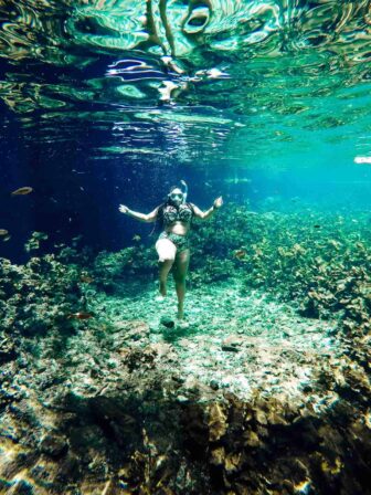 Jessica underwater, wearing a snorkel.